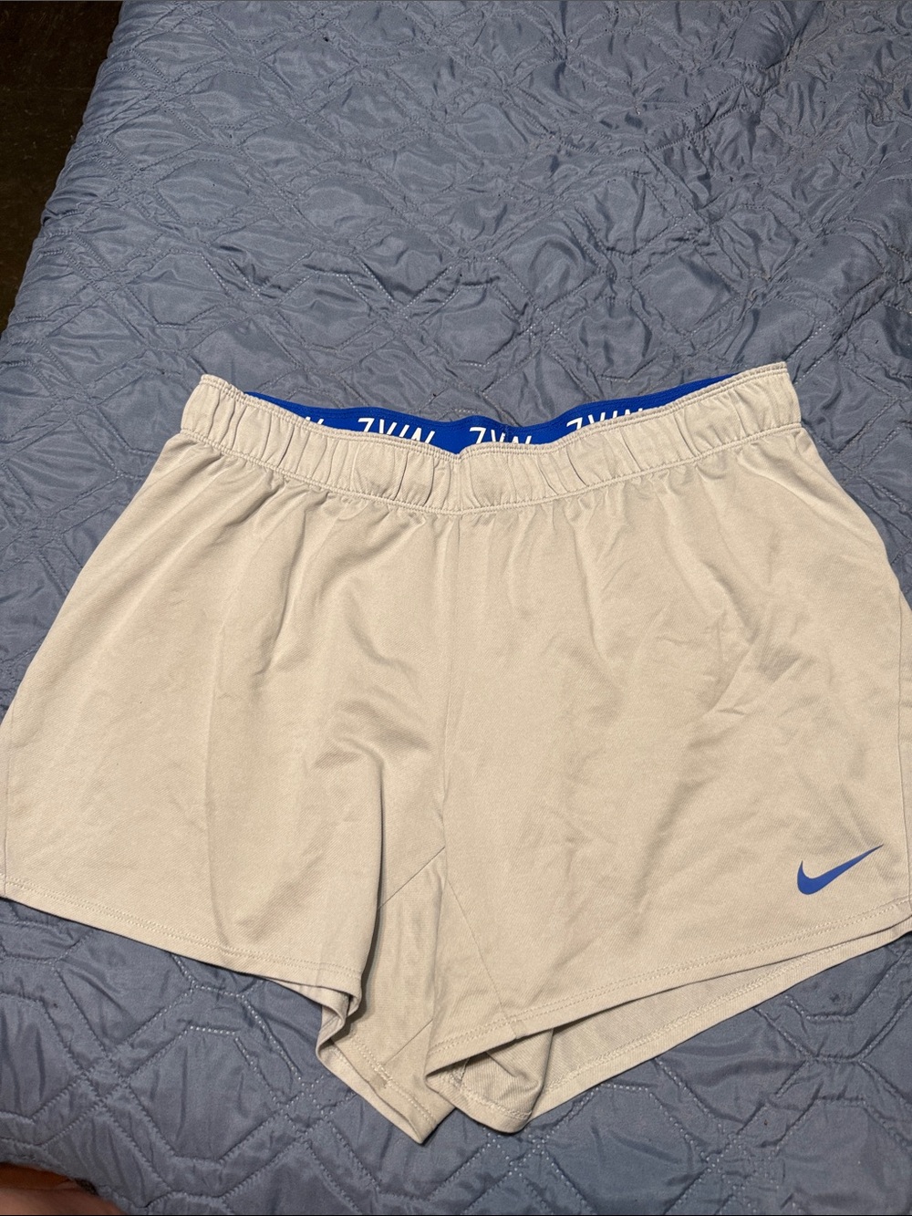Nike Women’s Light Tan Athletic Shorts with Blue Swoosh